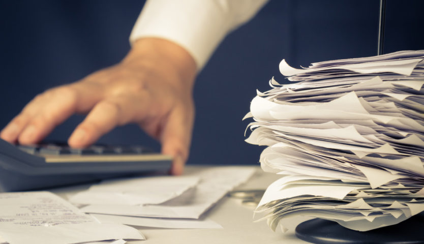 accountant-with-calculator-and-stack-of-paper