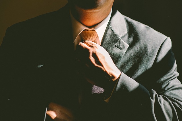 an-accontant-in-a-suit-straightening-their-tie