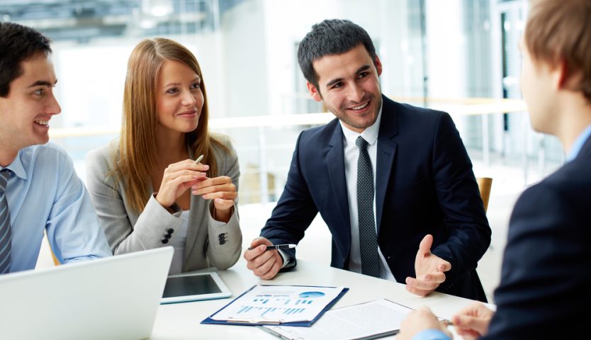 Image of business partners discussing documents and ideas at meeting