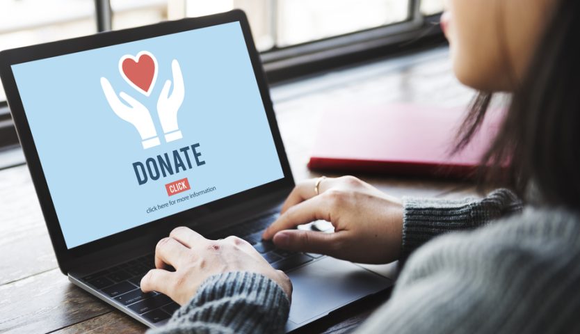 woman donating to charity on her laptop